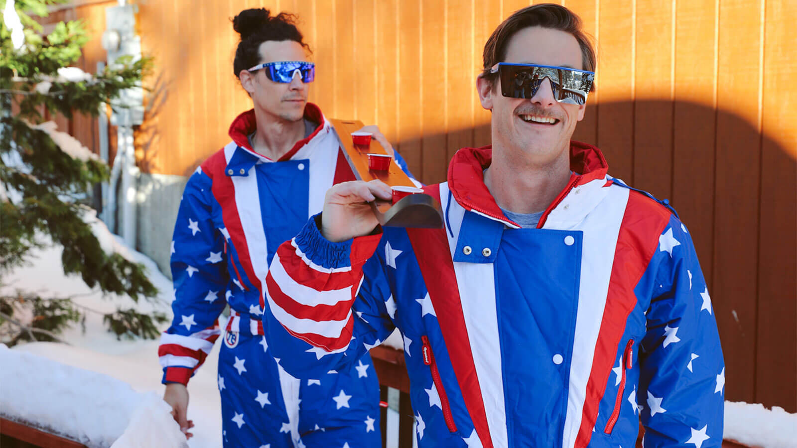 shop bachelor snow suits - image of two men wearing Americana Snow Suits and Say Can You See Sunglasses